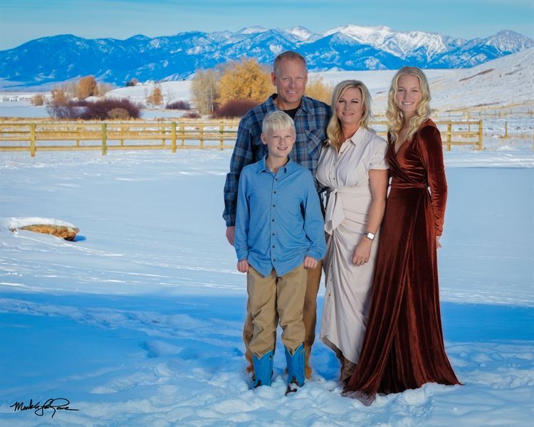 family standing in front of mountains